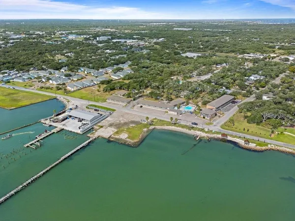 an aerial view of residential houses with outdoor space and swimming pool