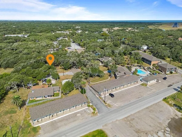 an aerial view of a house with a yard