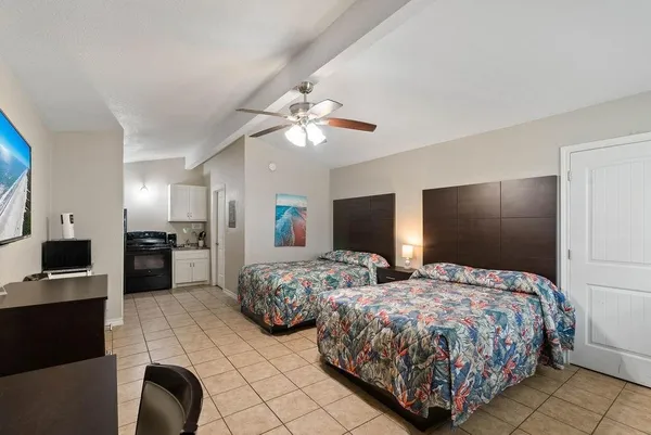 a bedroom with two bed and a television