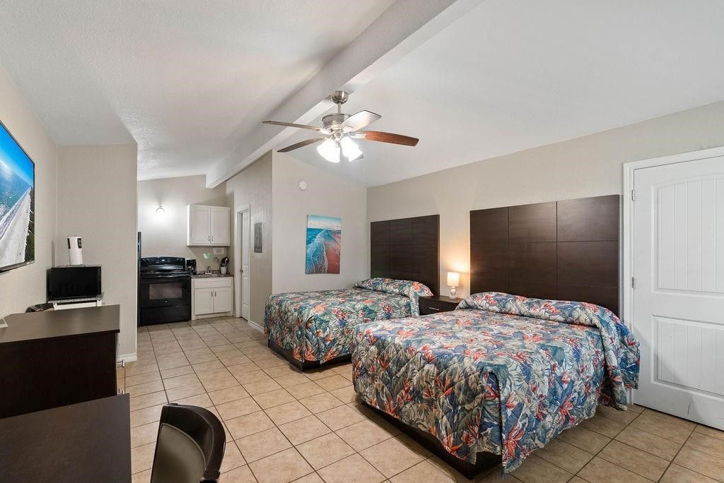 919 North Fulton Beach Road, Unit 324 Fulton, TX 78382 - Photo 4 of 21 a bedroom with two bed and a television