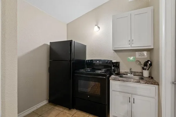 a kitchen with a refrigerator and cabinets