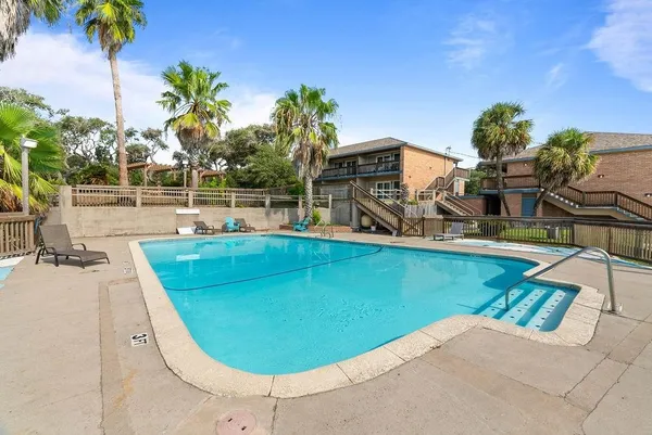 swimming pool view with a garden space