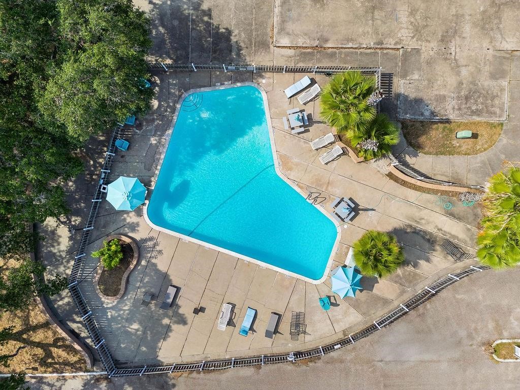 919 North Fulton Beach Road, Unit 324 Fulton, TX 78382 - Photo 10 of 21 a view of a swimming pool with potted plants