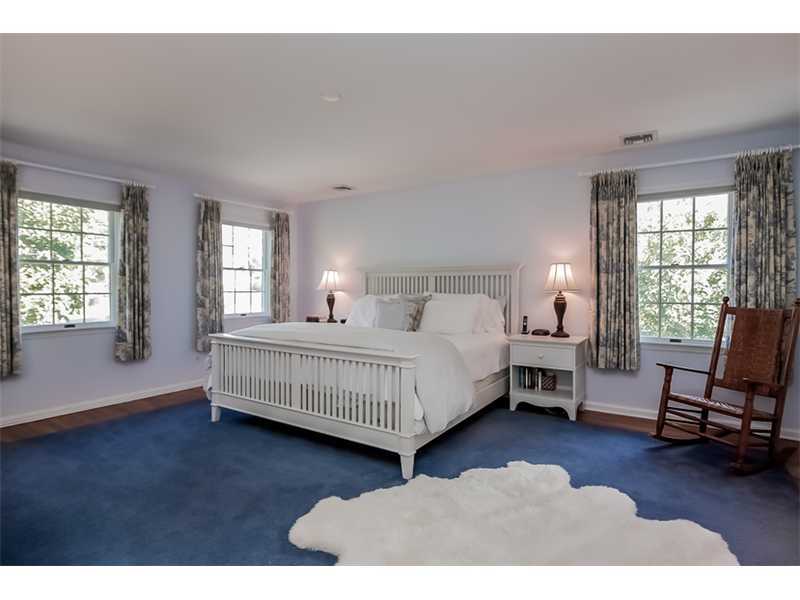 18 Devon Road Darien, CT 06820 - Photo 13 of 25 a bedroom with a bed chair and a window