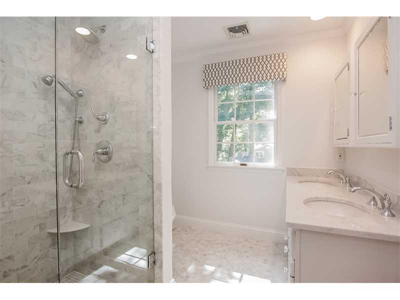 18 Devon Road Darien, CT 06820 - Photo 15 of 25 a bathroom with a sink a mirror and a shower