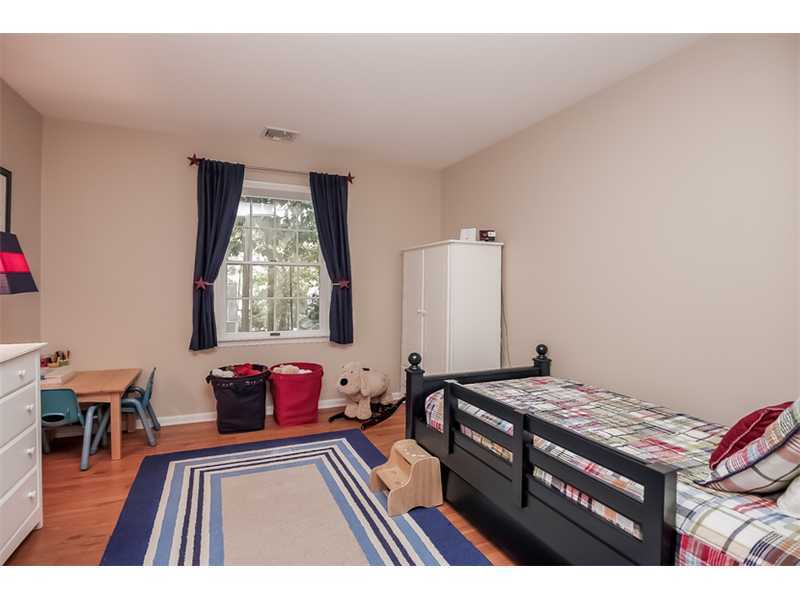 18 Devon Road Darien, CT 06820 - Photo 18 of 25 a bedroom with a bed and wooden floor