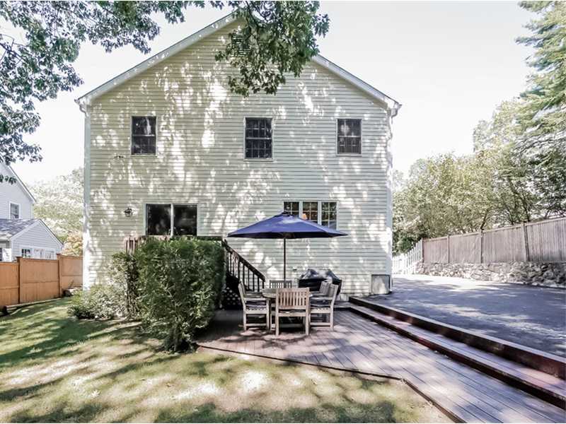 18 Devon Road Darien, CT 06820 - Photo 20 of 25 a patio with a table and chairs under an umbrella