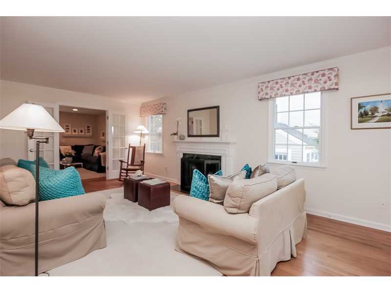 18 Devon Road Darien, CT 06820 - Photo 5 of 25 a living room with furniture a fireplace and a large mirror