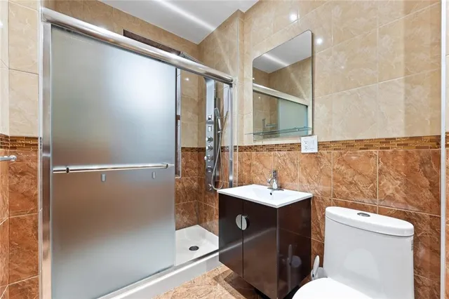 a bathroom with a sink and mirror with toilet