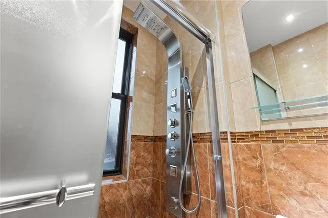 a bathroom with a toilet and a shower