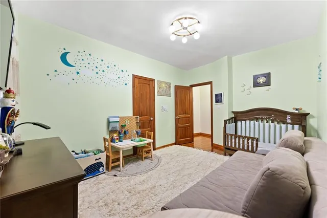 a bedroom with a bed and a chandelier