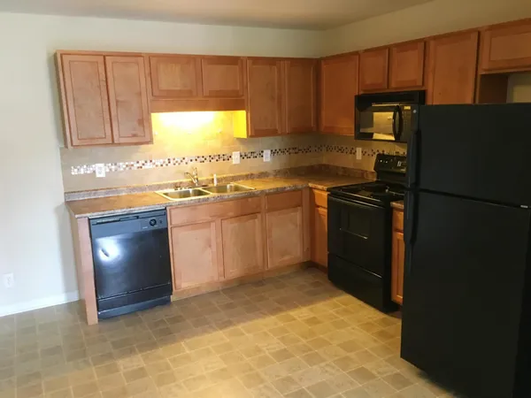a kitchen with a sink a stove and refrigerator