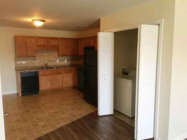 a kitchen with stainless steel appliances granite countertop a refrigerator and a stove