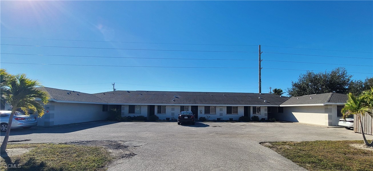 930 Southwest 47th Terrace, Unit 7 Cape Coral, FL 33914 - Photo 1 of 29 a front view of a house with a yard
