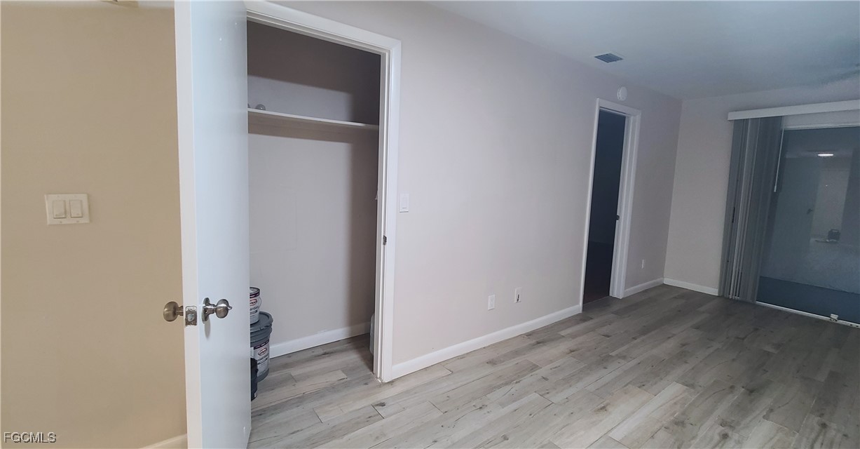 930 Southwest 47th Terrace, Unit 7 Cape Coral, FL 33914 - Photo 16 of 29 an empty room with wooden floor closet and windows