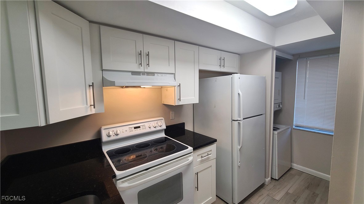 930 Southwest 47th Terrace, Unit 7 Cape Coral, FL 33914 - Photo 6 of 29 a kitchen with a refrigerator stove and cabinets