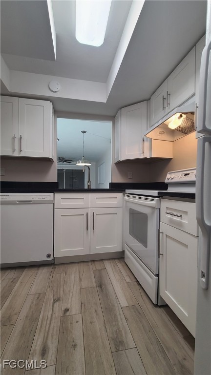 930 Southwest 47th Terrace, Unit 7 Cape Coral, FL 33914 - Photo 7 of 29 a kitchen with white cabinets and white appliances