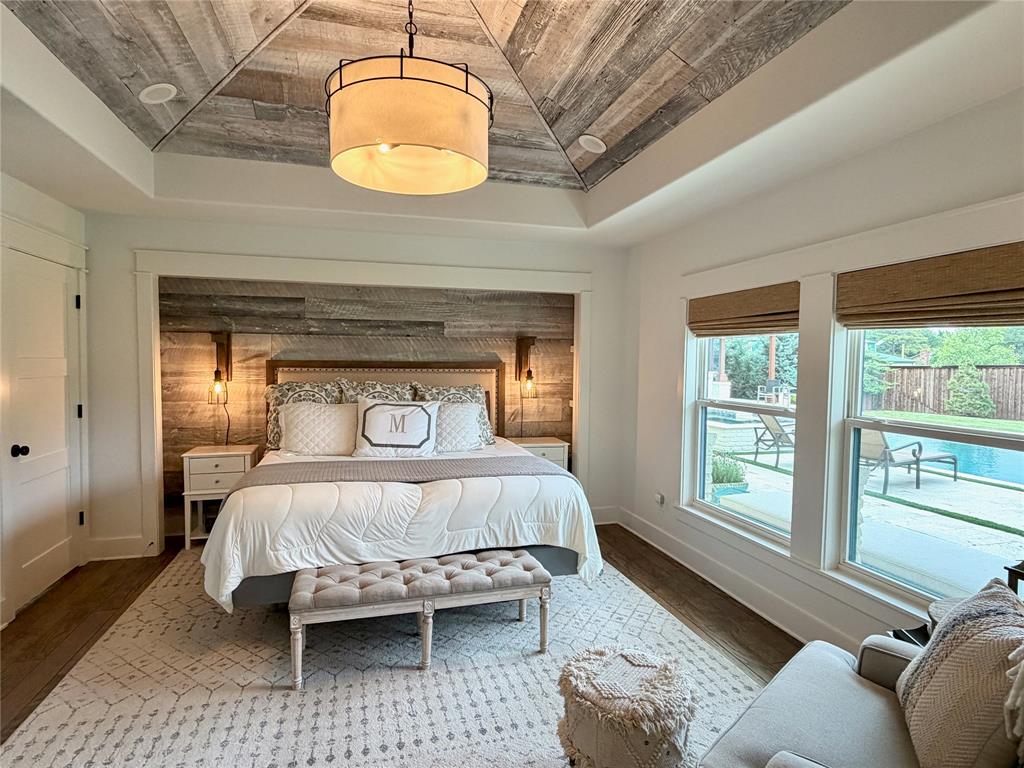 1304 Tinker Road Colleyville, TX 76034 - Photo 9 of 28 a bedroom with a large bed and a chandelier