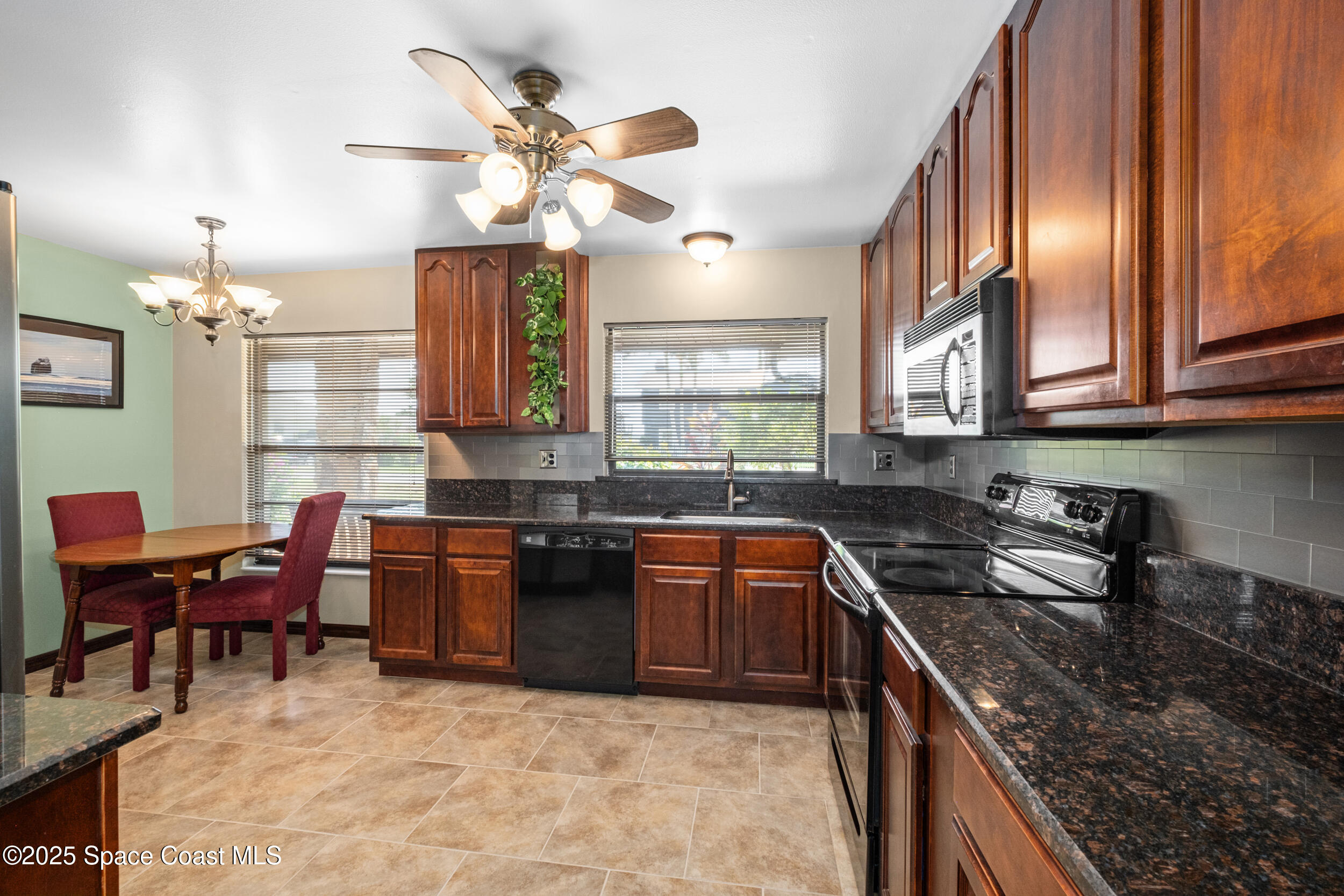 1170 Faulkingham Road Merritt Island, FL 32952 - Photo 11 of 31 a kitchen with stainless steel appliances granite countertop a sink dishwasher stove and cabinets