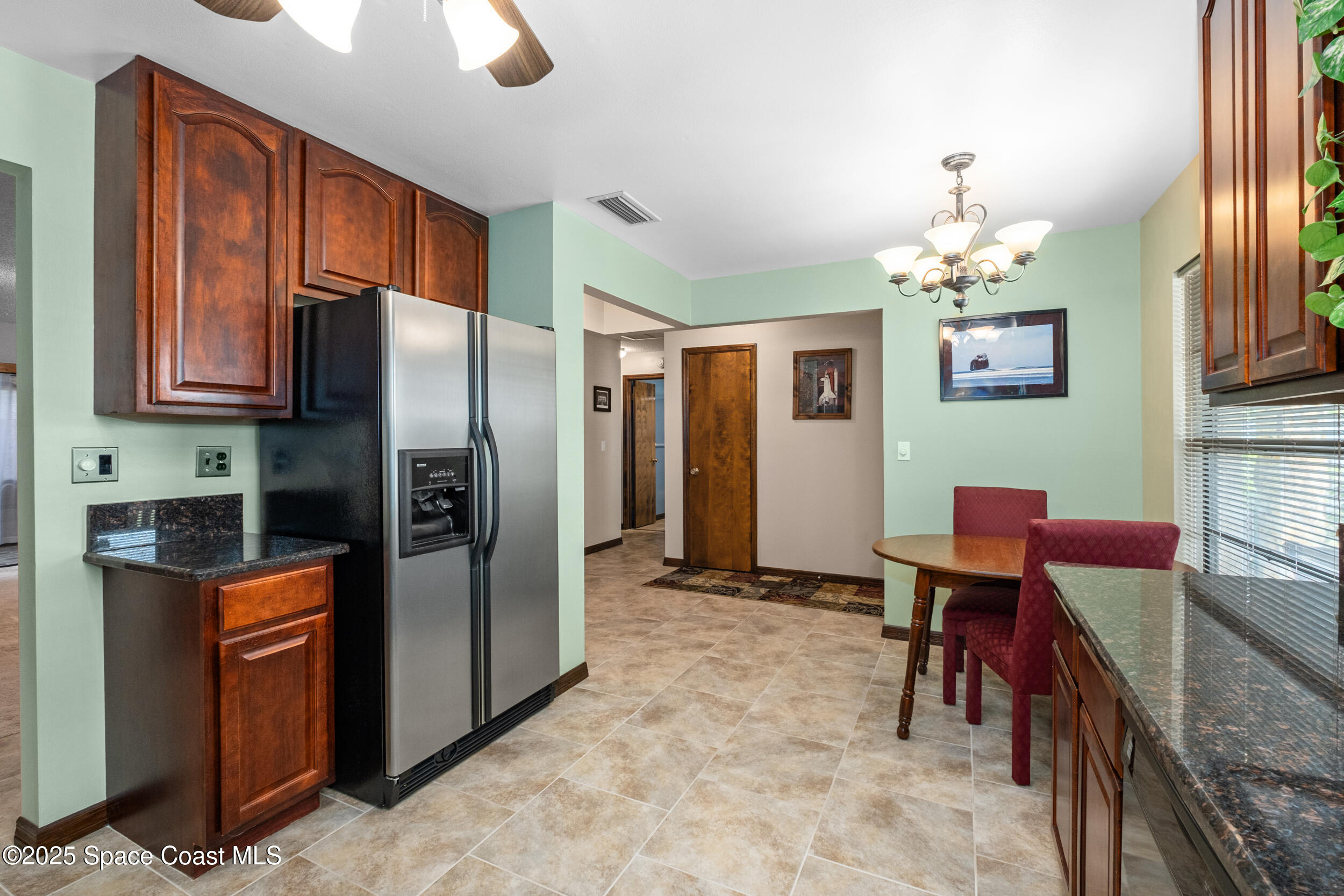 1170 Faulkingham Road Merritt Island, FL 32952 - Photo 12 of 31 a kitchen with stainless steel appliances granite countertop a refrigerator and a stove top oven
