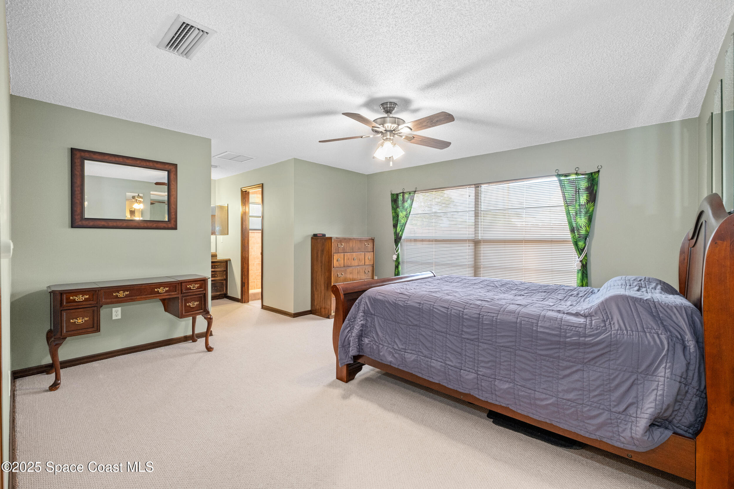 1170 Faulkingham Road Merritt Island, FL 32952 - Photo 13 of 31 a bed room with a bed and a chandelier