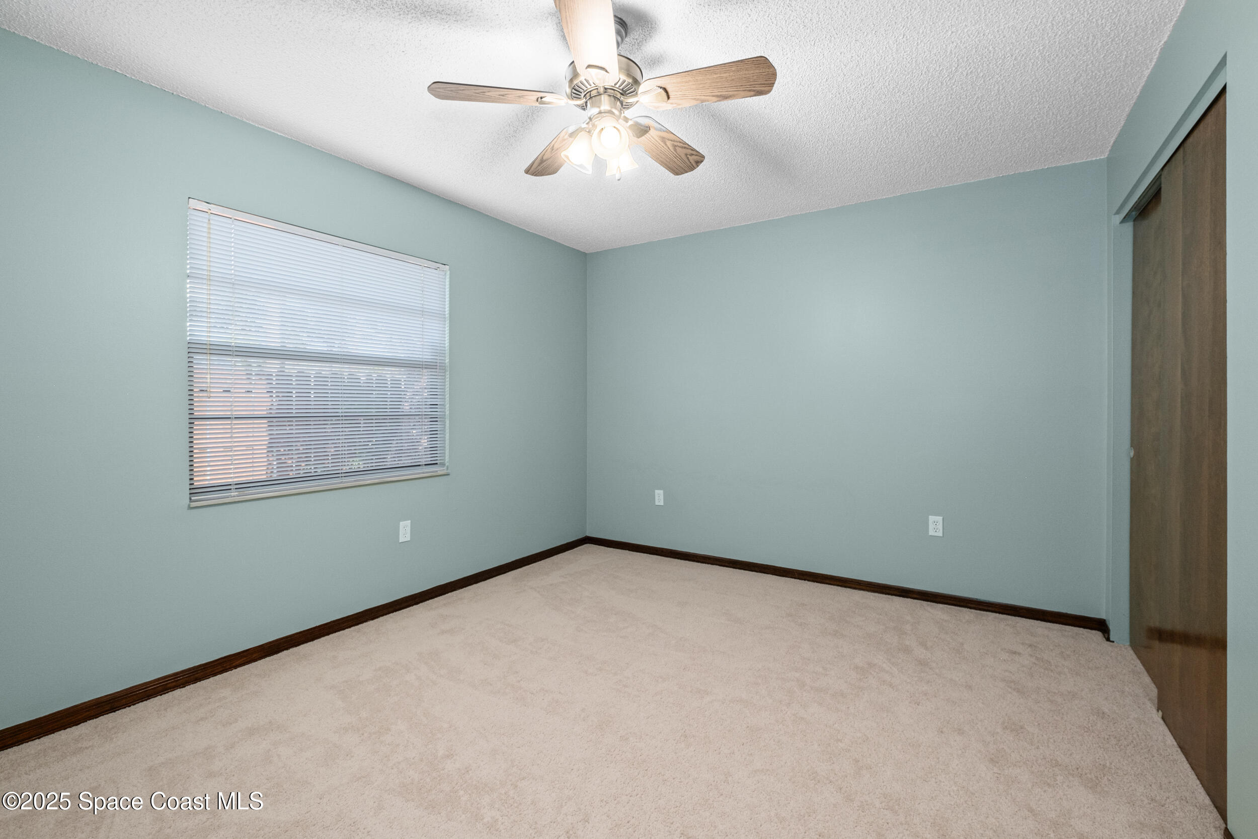 1170 Faulkingham Road Merritt Island, FL 32952 - Photo 20 of 31 an empty room with a window and a fan