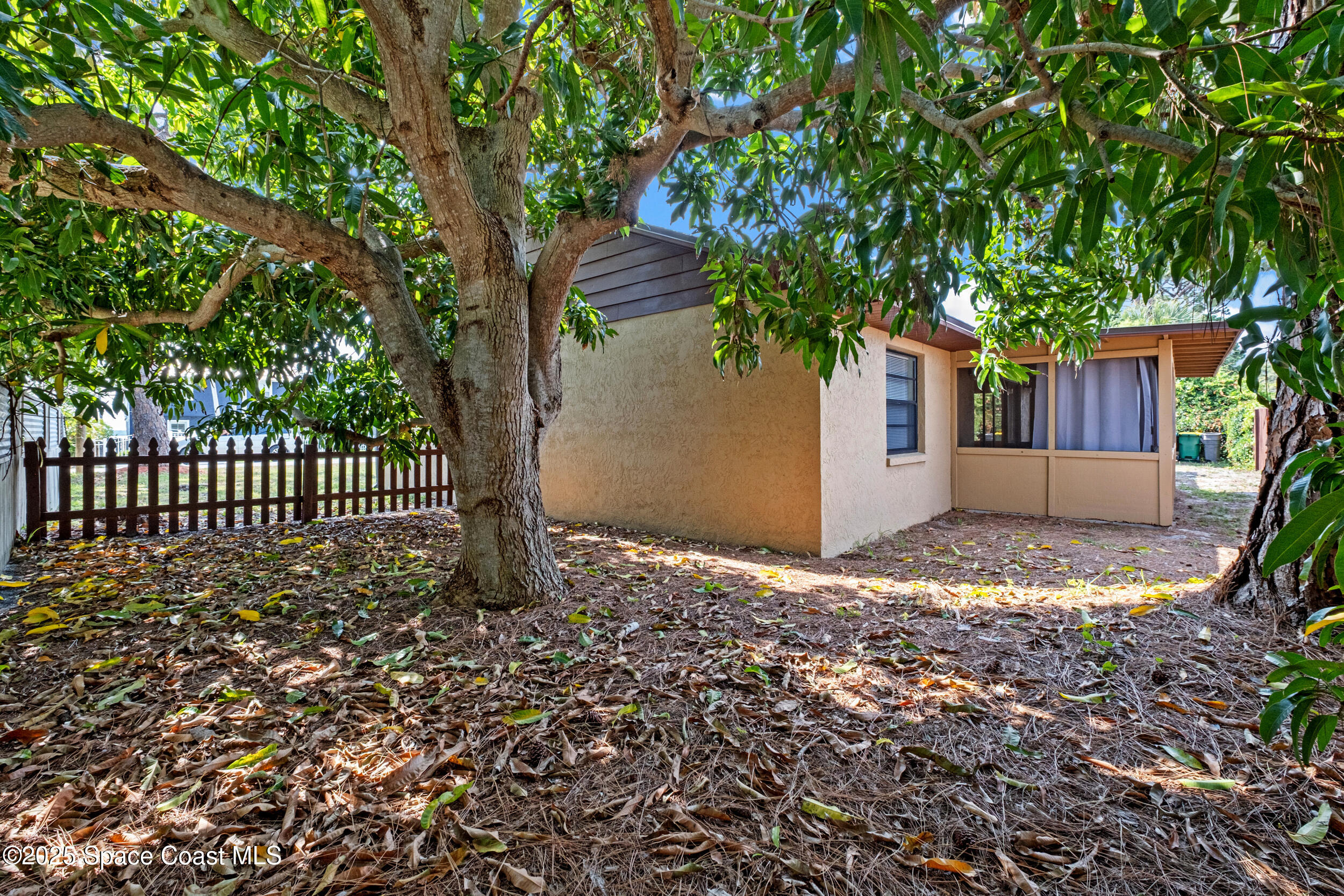 1170 Faulkingham Road Merritt Island, FL 32952 - Photo 25 of 31 a house with trees in front of it