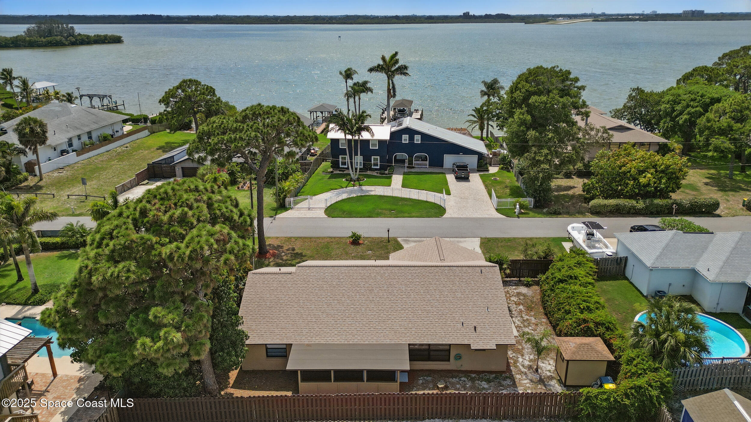 1170 Faulkingham Road Merritt Island, FL 32952 - Photo 26 of 31 an aerial view of a house with a swimming pool outdoor seating and yard