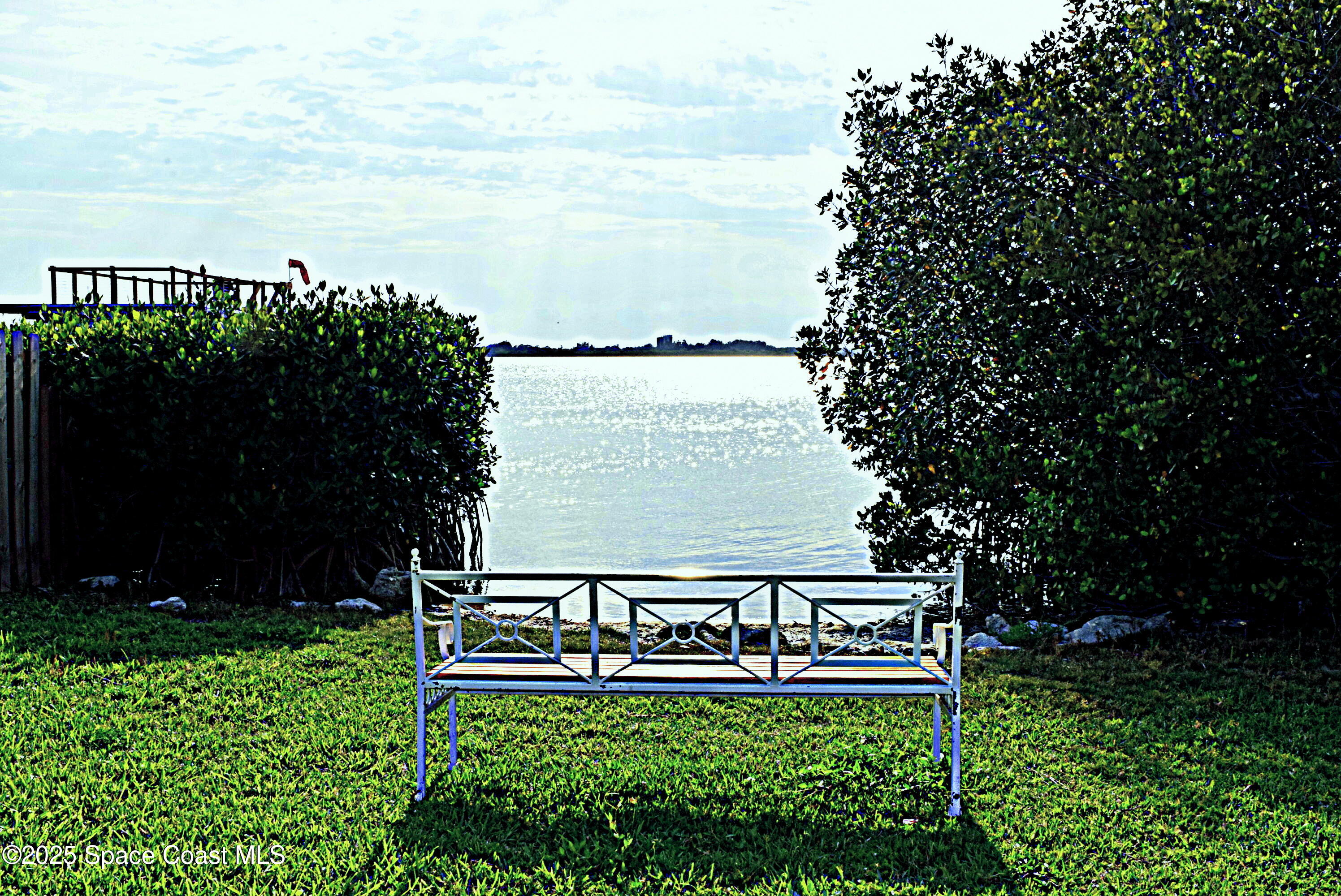 1170 Faulkingham Road Merritt Island, FL 32952 - Photo 3 of 31 a view of a bench in front of house and trees