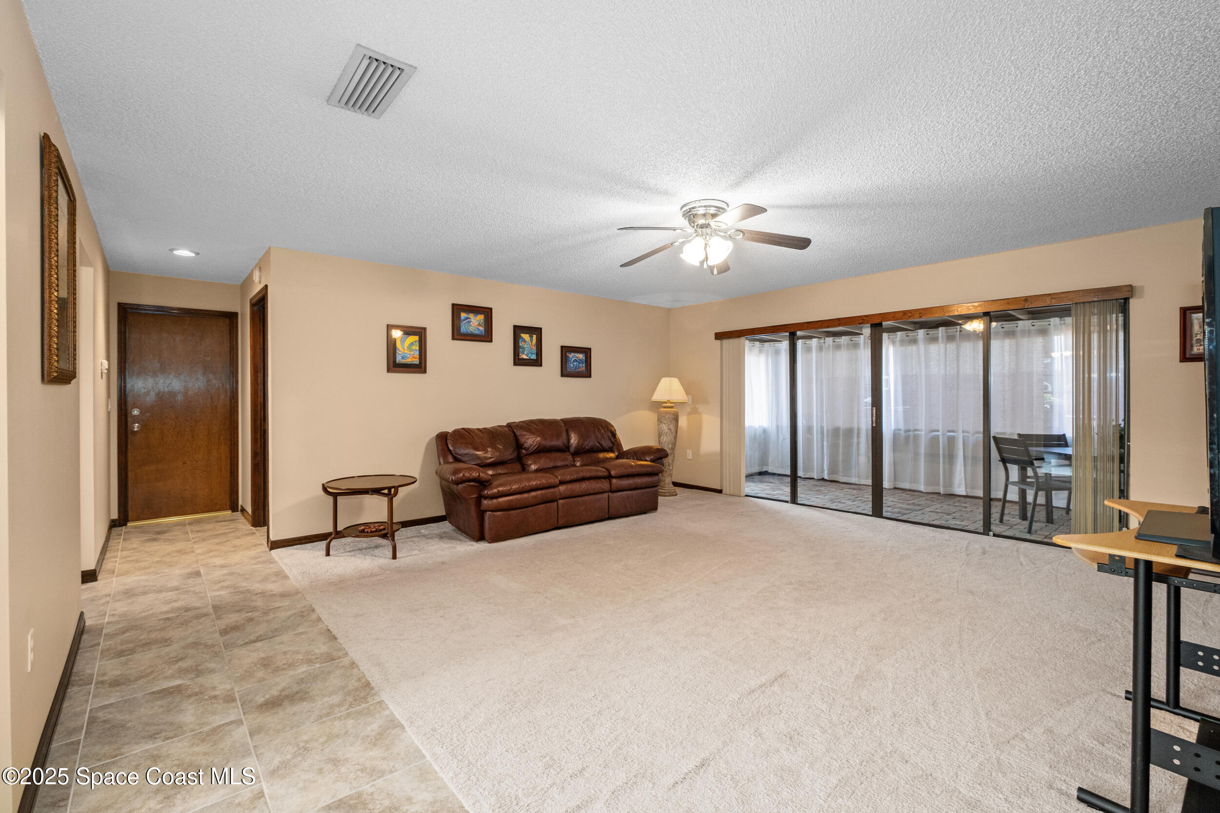 1170 Faulkingham Road Merritt Island, FL 32952 - Photo 7 of 31 a spacious bedroom with a bed and a chandelier