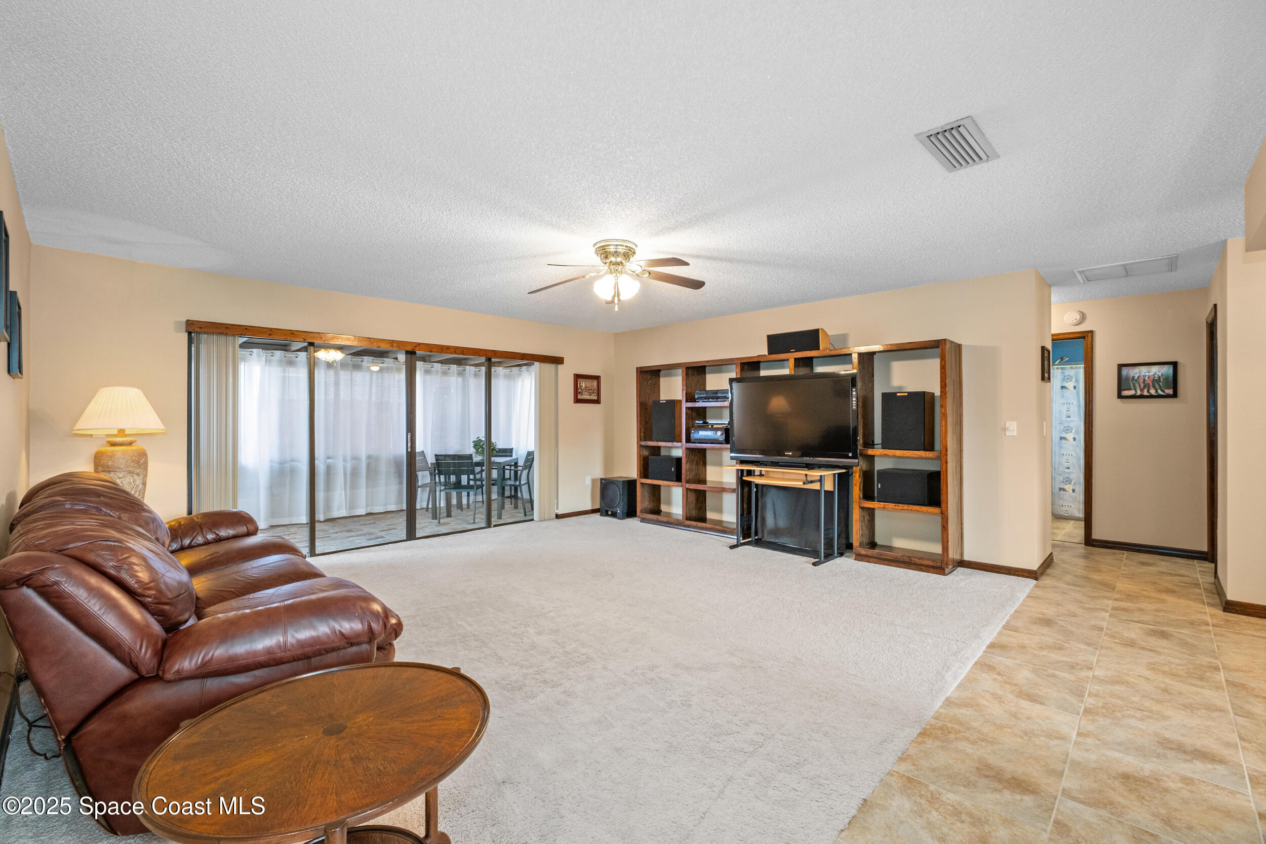 1170 Faulkingham Road Merritt Island, FL 32952 - Photo 9 of 31 a living room with furniture and a flat screen tv