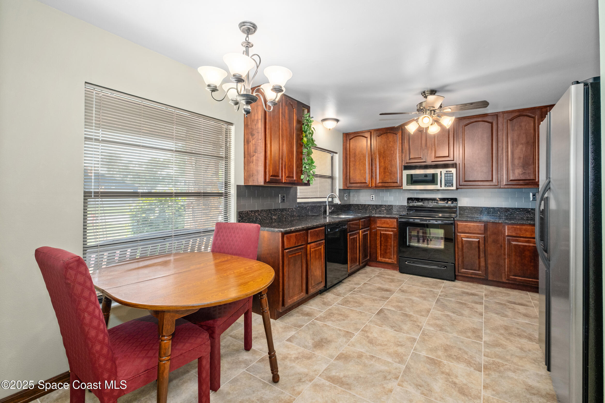 1170 Faulkingham Road Merritt Island, FL 32952 - Photo 10 of 31 a kitchen with a refrigerator a stove a sink dishwasher with a dining table and chairs