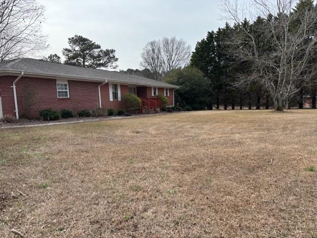 2215 Oak Hill Road Covington, GA 30016 - Photo 4 of 36 a view of a yard in front of a house with large tree