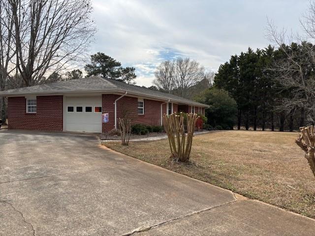2215 Oak Hill Road Covington, GA 30016 - Photo 6 of 36 a view of a house with a yard and garage