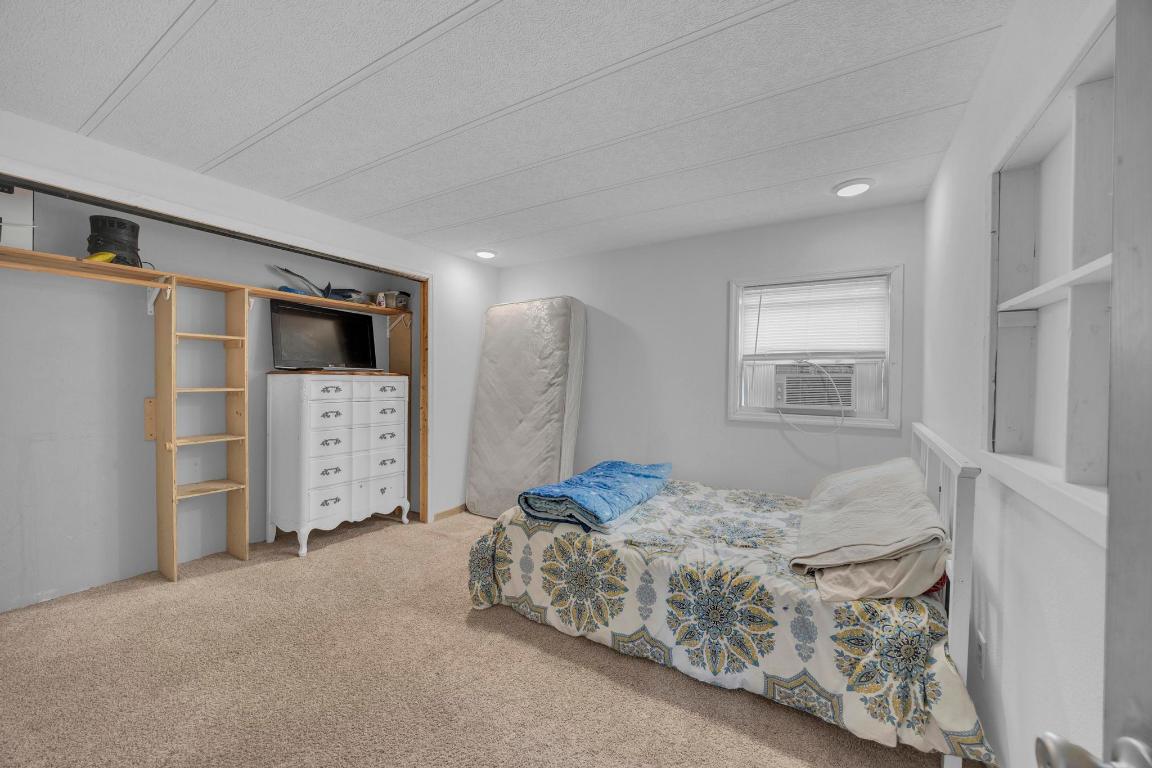 106 Cloudberry Lane Elgin, TX 78621 - Photo 17 of 33 a bedroom with a bed and a refrigerator