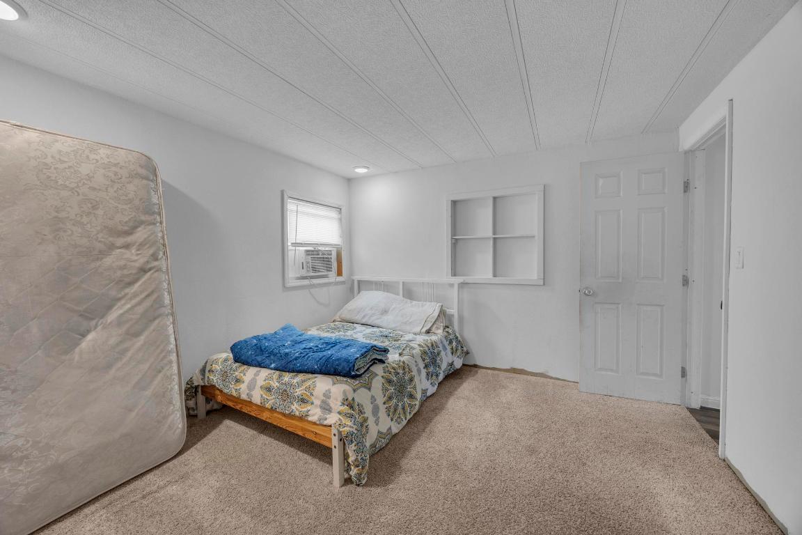 106 Cloudberry Lane Elgin, TX 78621 - Photo 18 of 33 a bedroom with a bed and a window