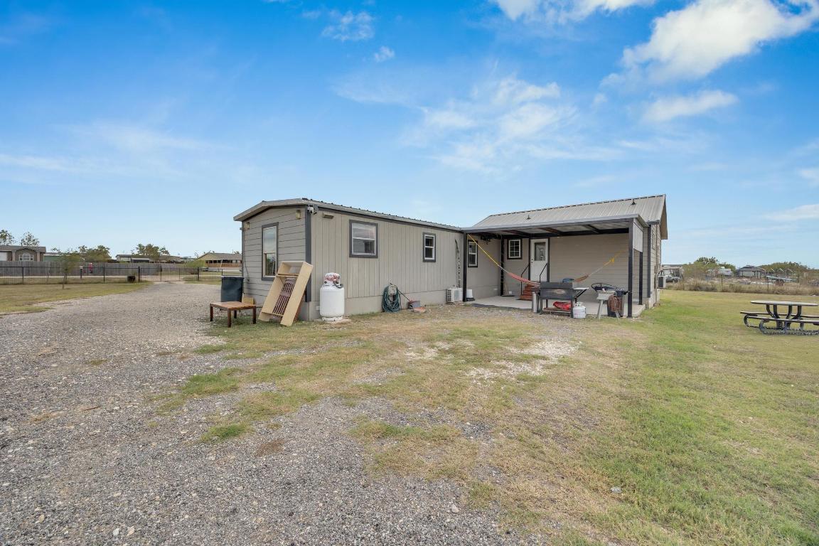 106 Cloudberry Lane Elgin, TX 78621 - Photo 24 of 33 a view of a lake with a house