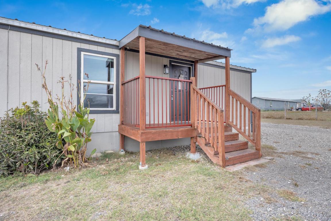 106 Cloudberry Lane Elgin, TX 78621 - Photo 4 of 33 a view of wooden house with a yard and plants