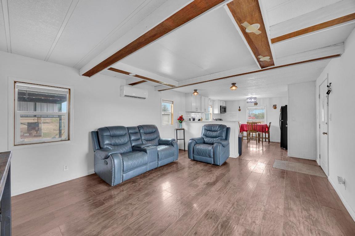 106 Cloudberry Lane Elgin, TX 78621 - Photo 7 of 33 a living room with furniture and a wooden floor