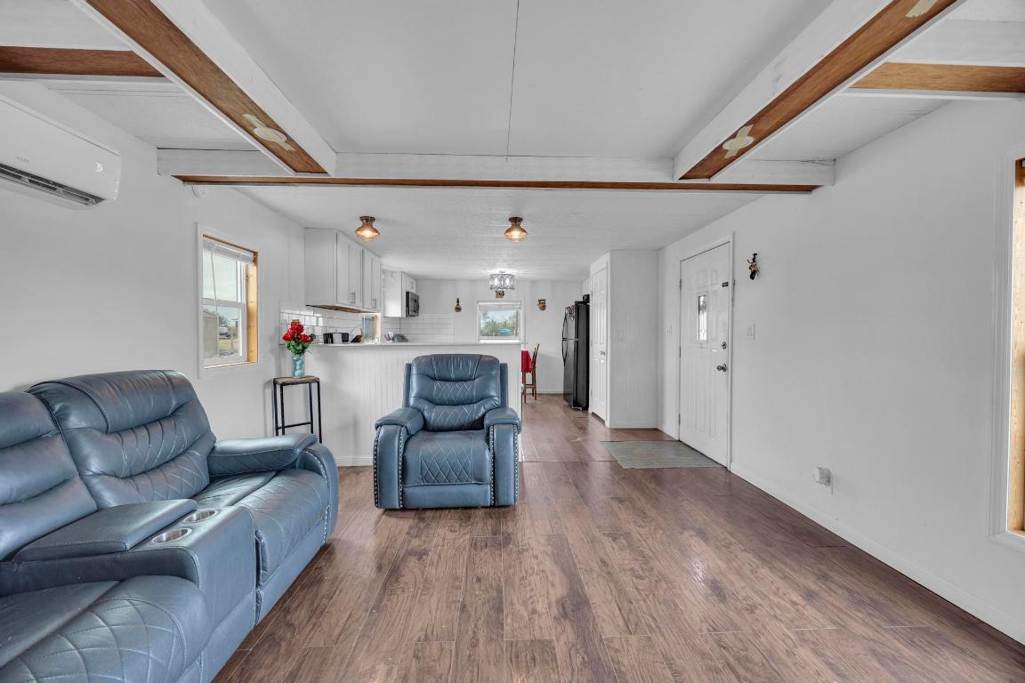 106 Cloudberry Lane Elgin, TX 78621 - Photo 9 of 33 a living room with furniture and a wooden floor