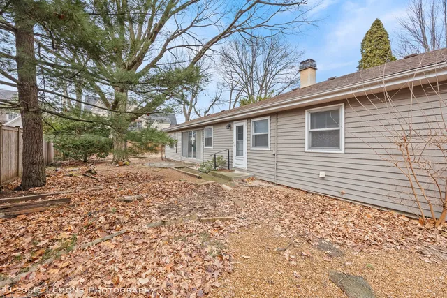 a backyard of a house with large trees