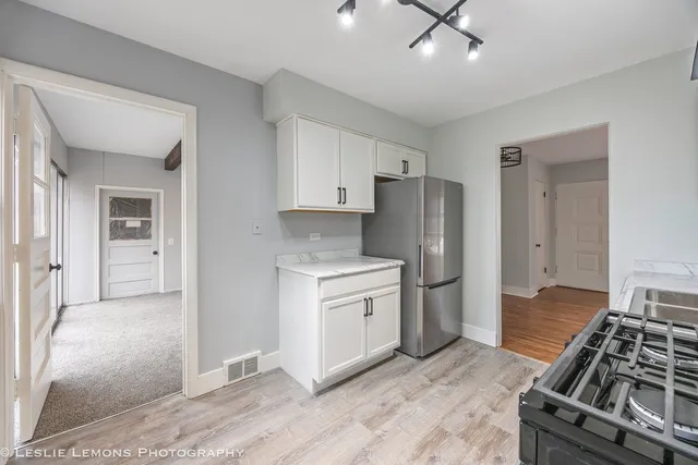 a kitchen with a stove and a refrigerator