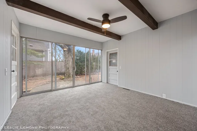 a view of an empty room with glass door