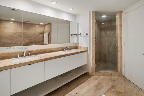 a bathroom with a sink double vanity and a shower