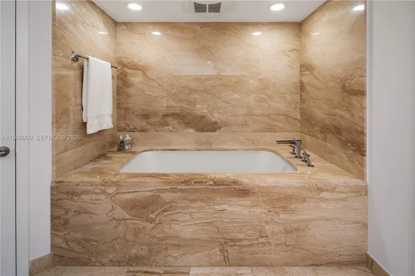 a bathroom with a bathtub and shower