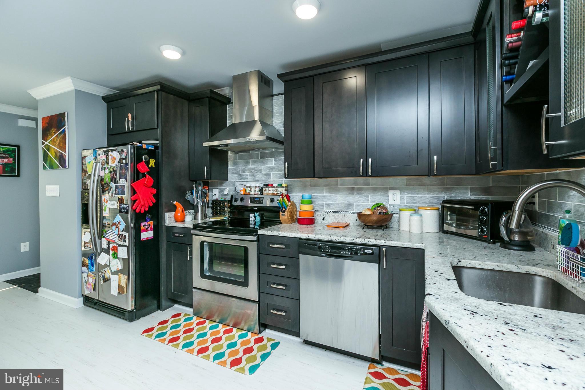 2 West Lee Street, Unit R59 Baltimore, MD 21201 - Photo 11 of 28 a kitchen with stainless steel appliances granite countertop a sink stove and refrigerator
