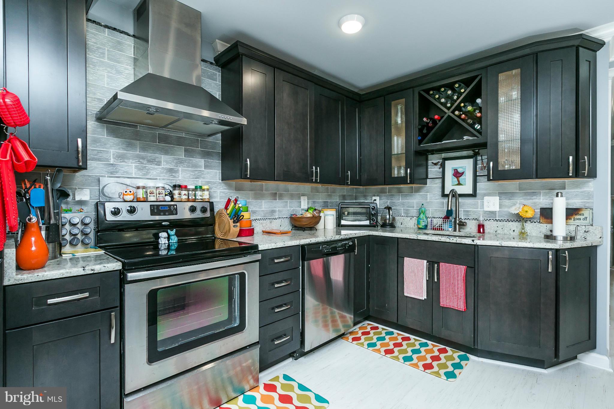 2 West Lee Street, Unit R59 Baltimore, MD 21201 - Photo 13 of 28 a kitchen with stainless steel appliances granite countertop a stove and cabinets