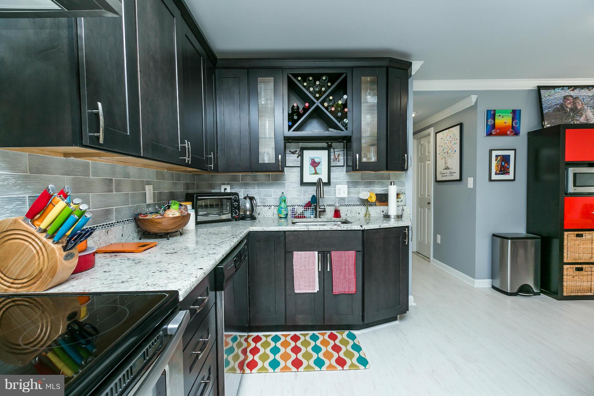 2 West Lee Street, Unit R59 Baltimore, MD 21201 - Photo 14 of 28 a kitchen with granite countertop lots of clutter and stainless steel appliances