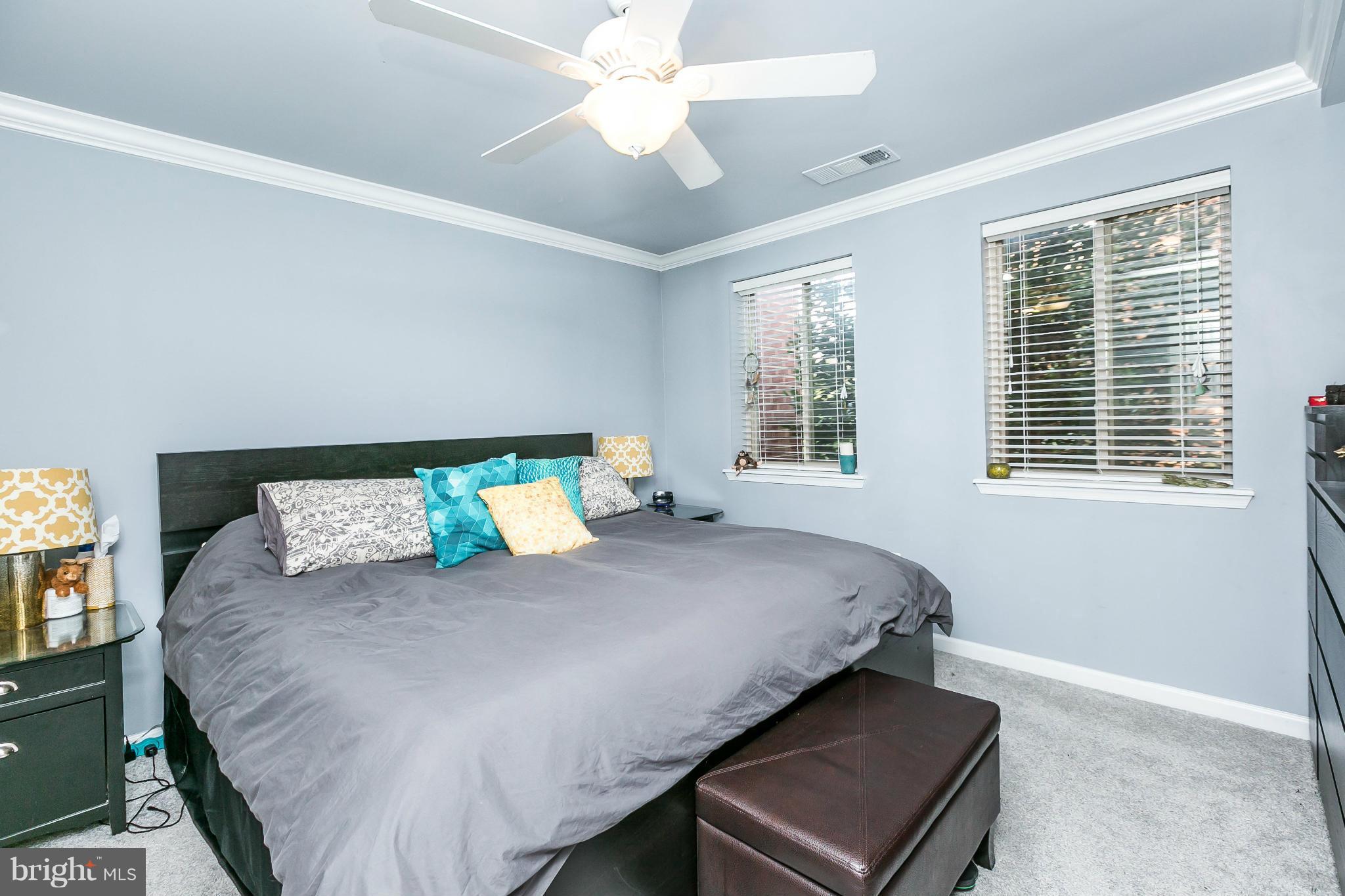 2 West Lee Street, Unit R59 Baltimore, MD 21201 - Photo 15 of 28 a large bed sitting in a bedroom next to a window