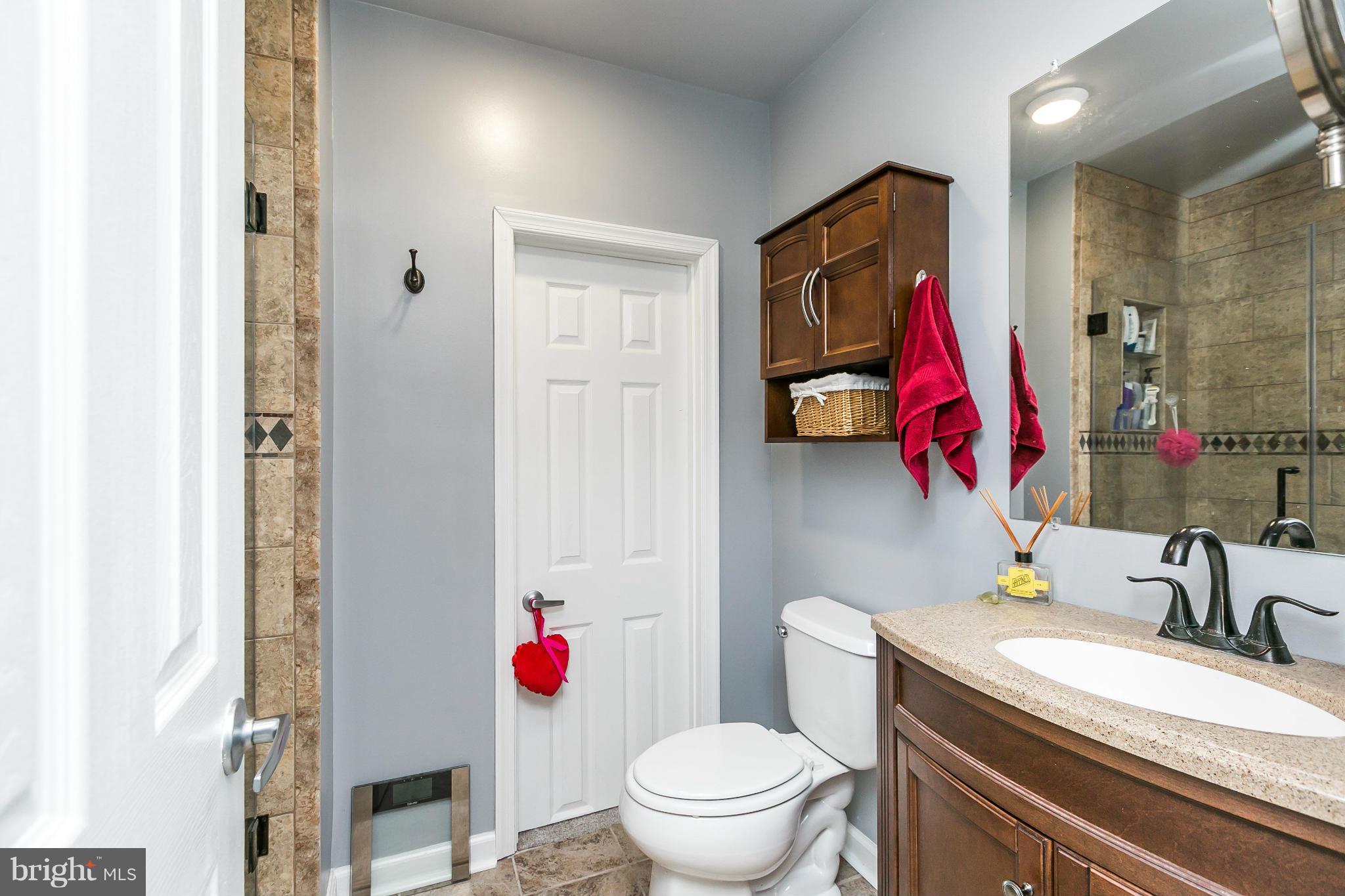 2 West Lee Street, Unit R59 Baltimore, MD 21201 - Photo 18 of 28 a bathroom with a sink vanity mirror and toilet